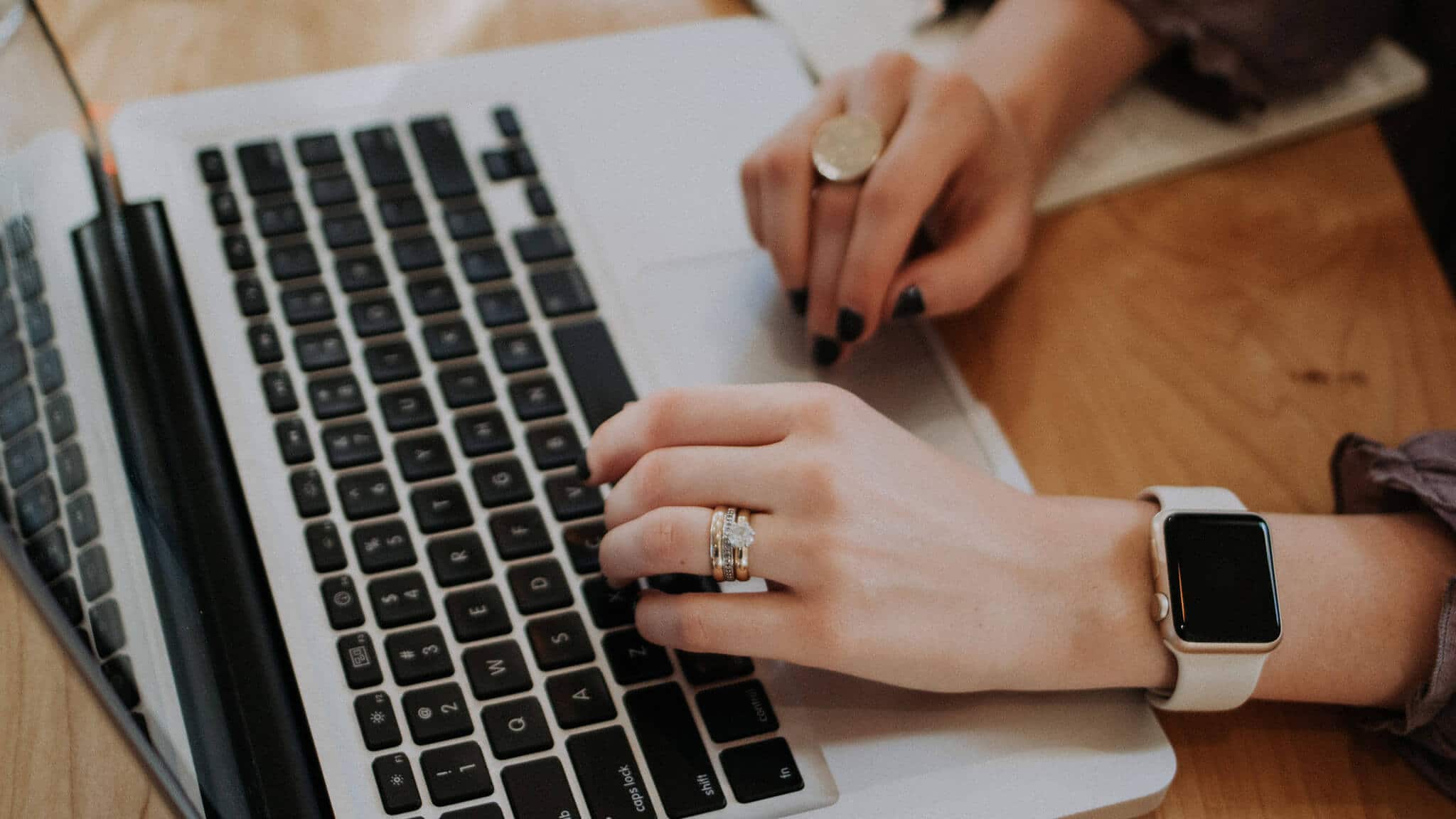 Close up of woman&#039;s hands typing on a laptop