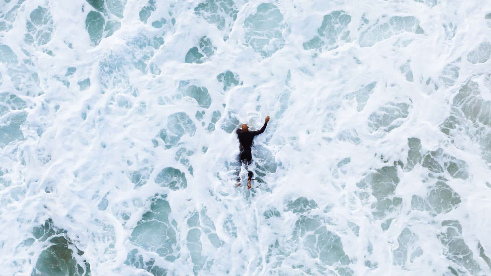Man swimming in choppy surf