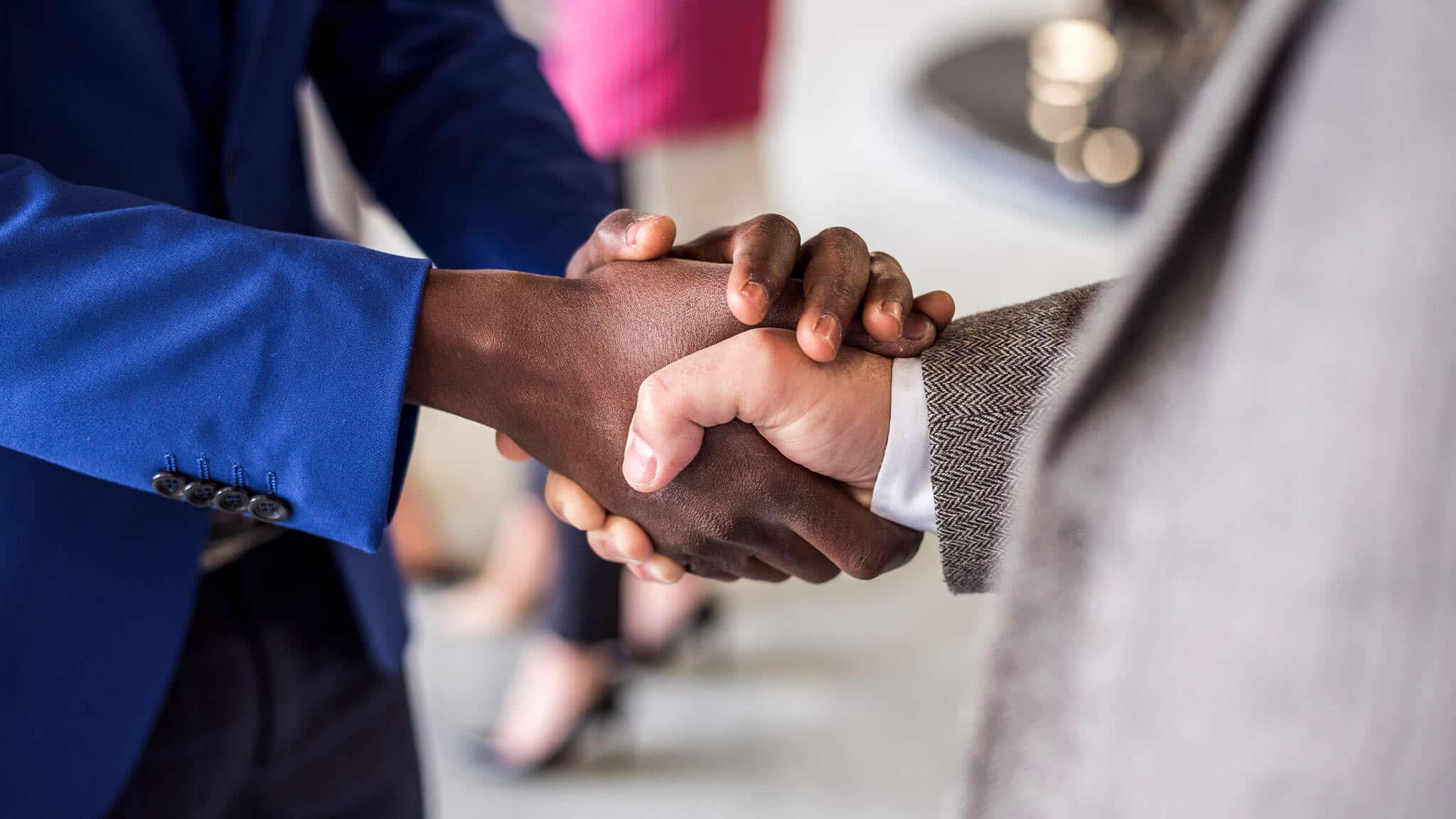 Close up shot of two men shaking hands