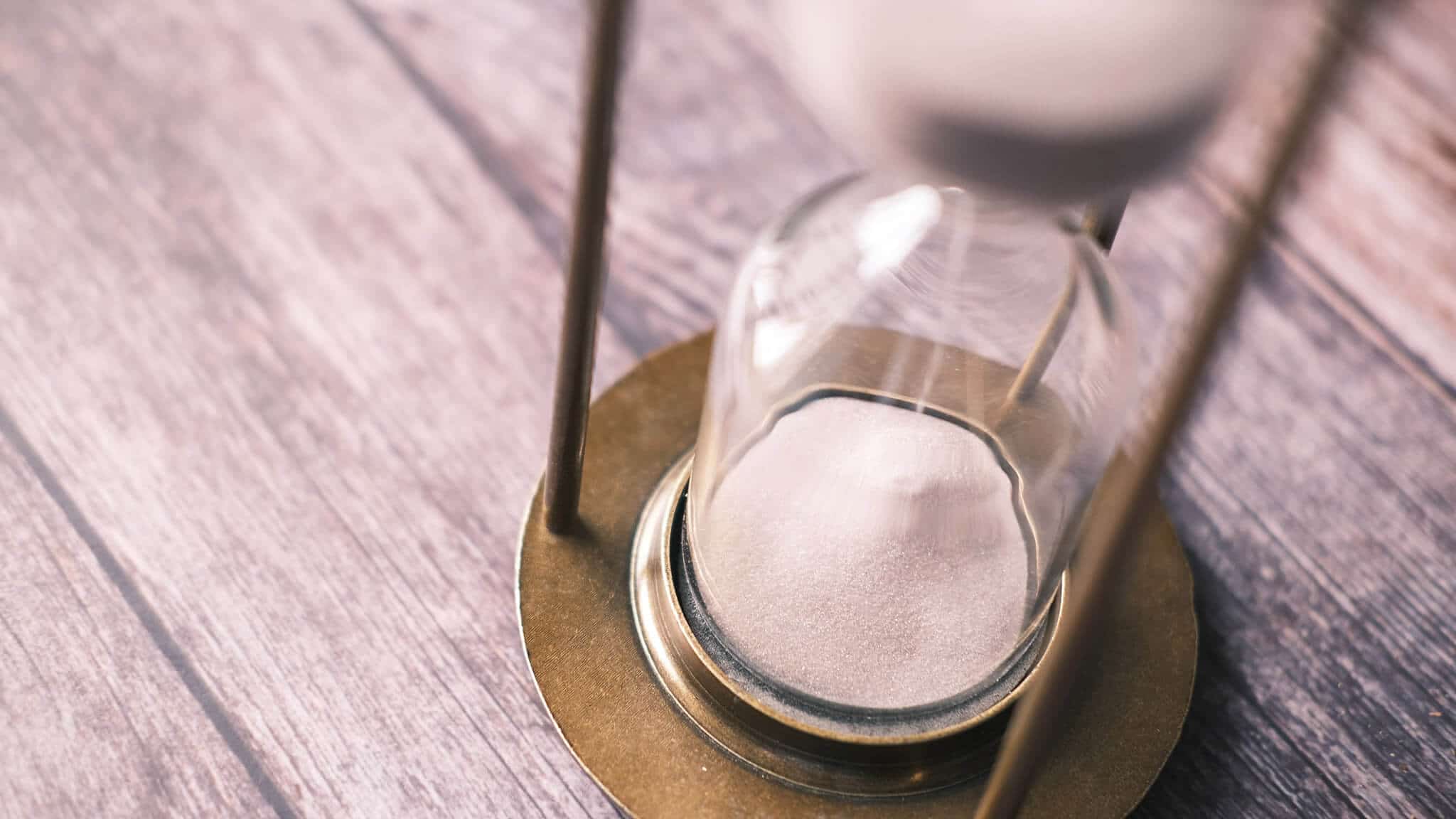 Close up of hourglass with running sand.