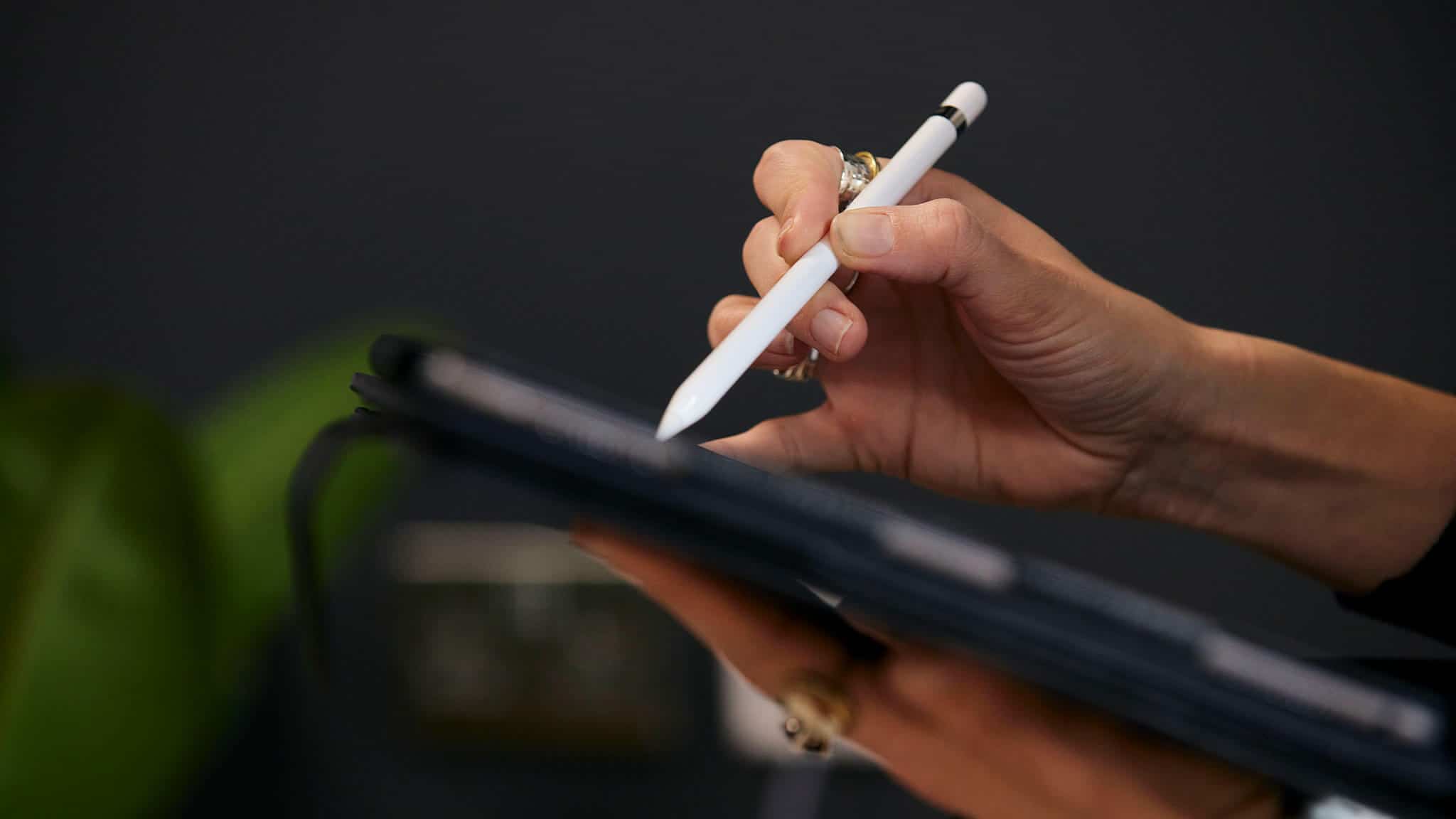 Close up of hands using stylus on a tablet