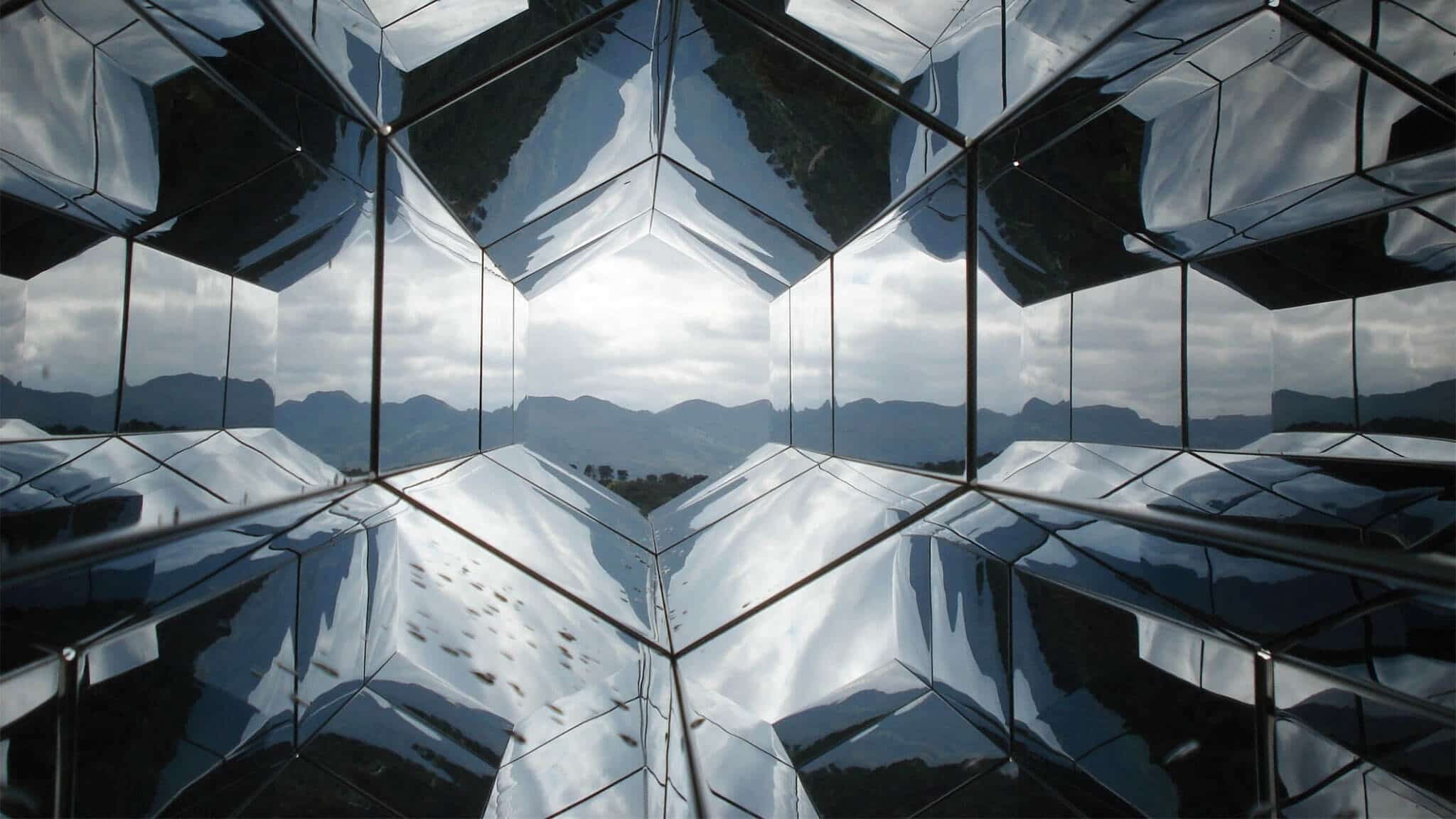 Wide angle shot of mountains through hexagonal windows