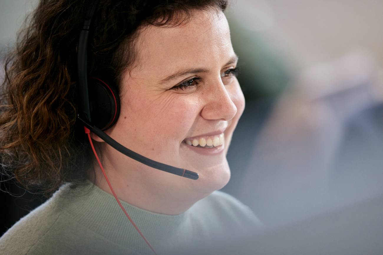 Kocho employee on headset smiling