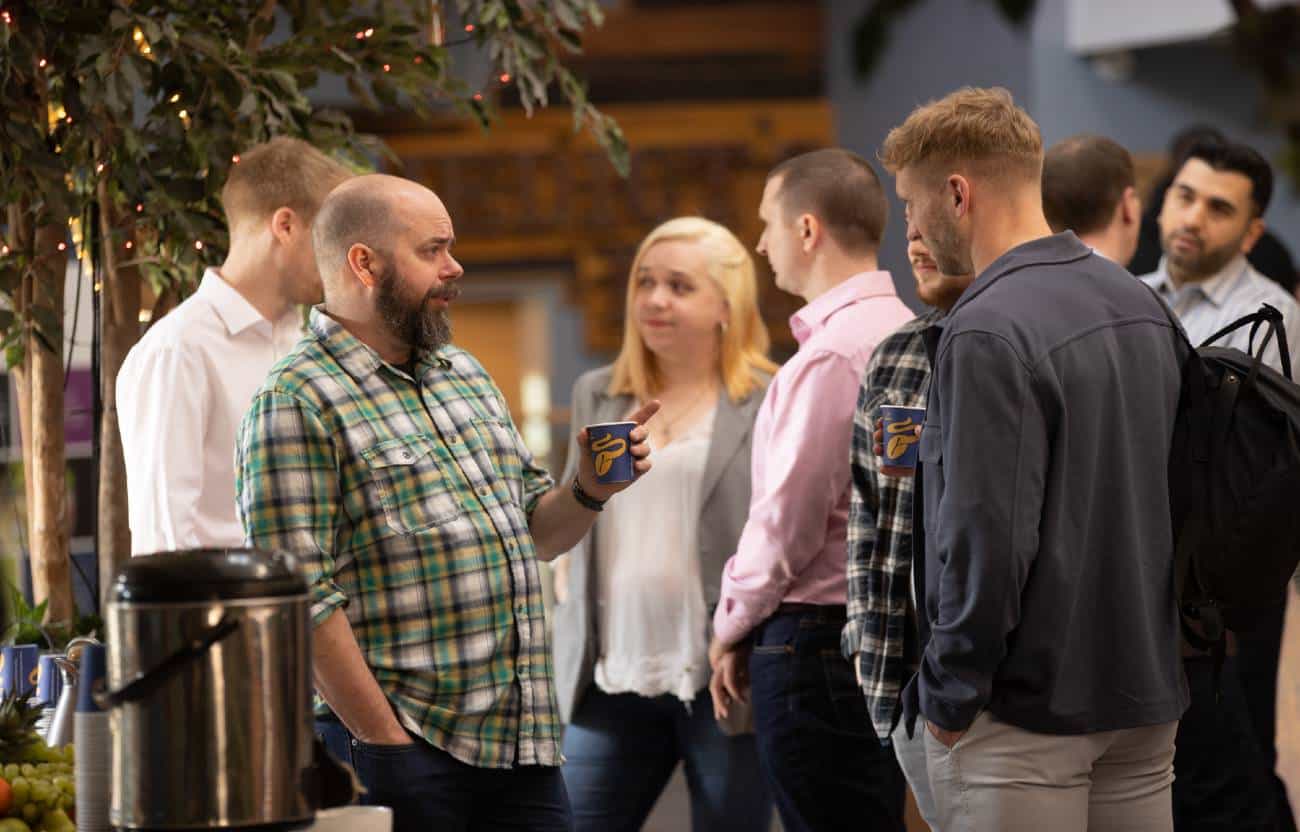 Kocho employee smiling during a group conversation