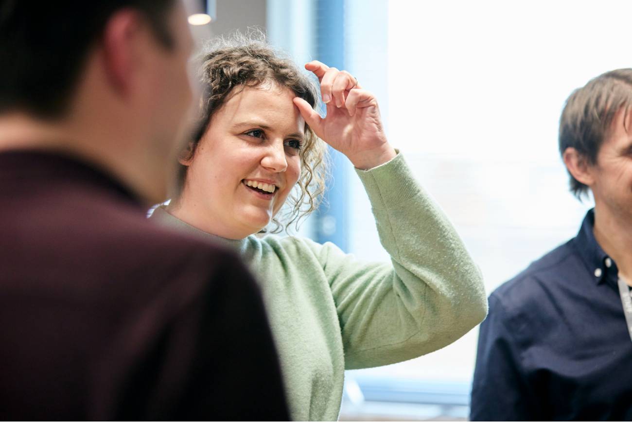 Kocho employee smiling during a group conversation